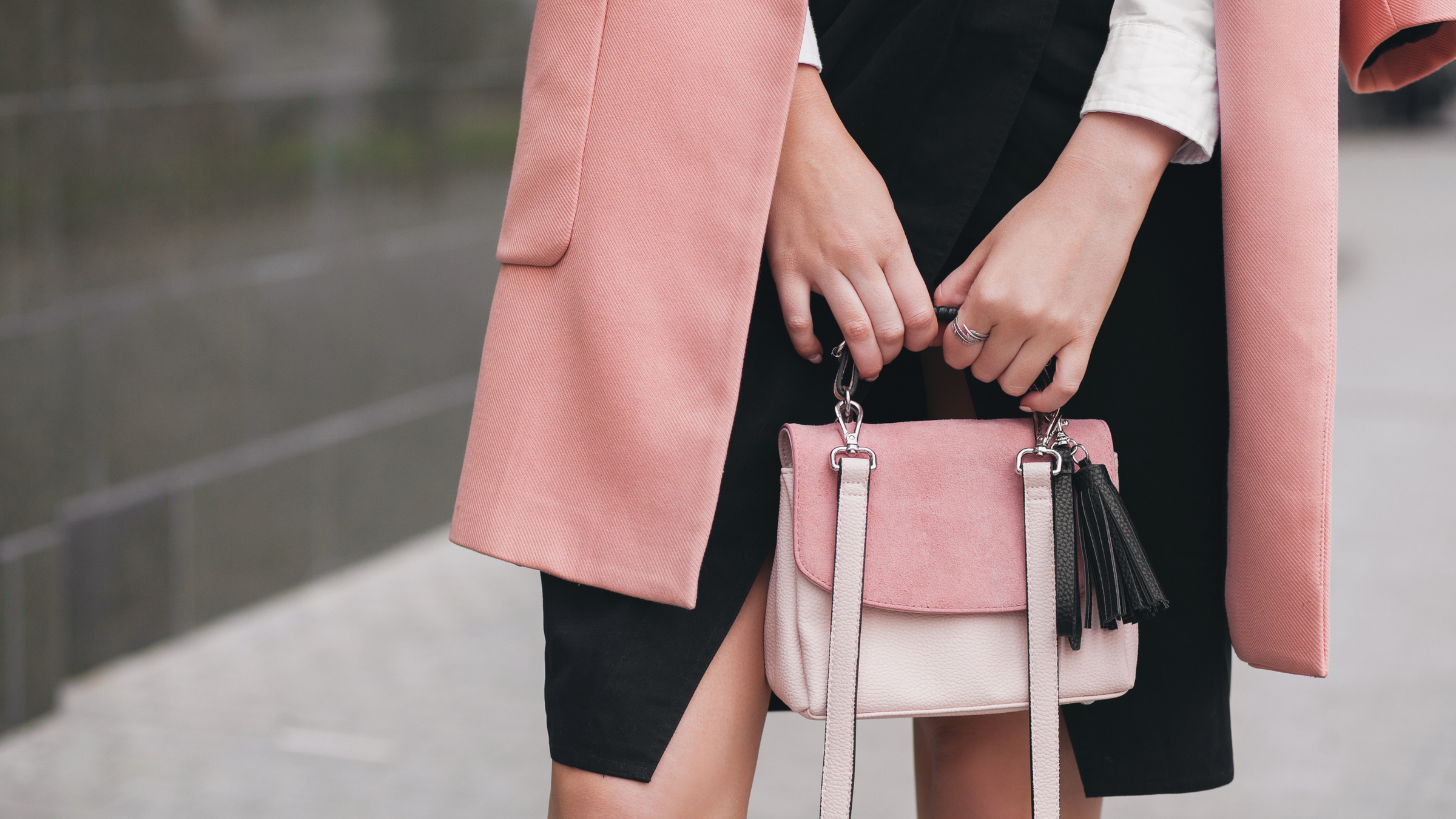 women's hands holding pink purse